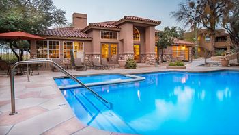 La reserve pool view with lounging area and trees surrounding
